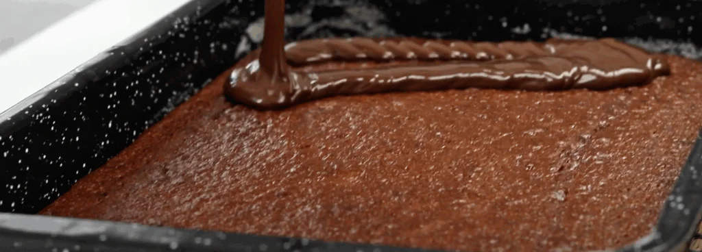 Na vychladlý korpus naneseme vrstvu čokoládového krému.