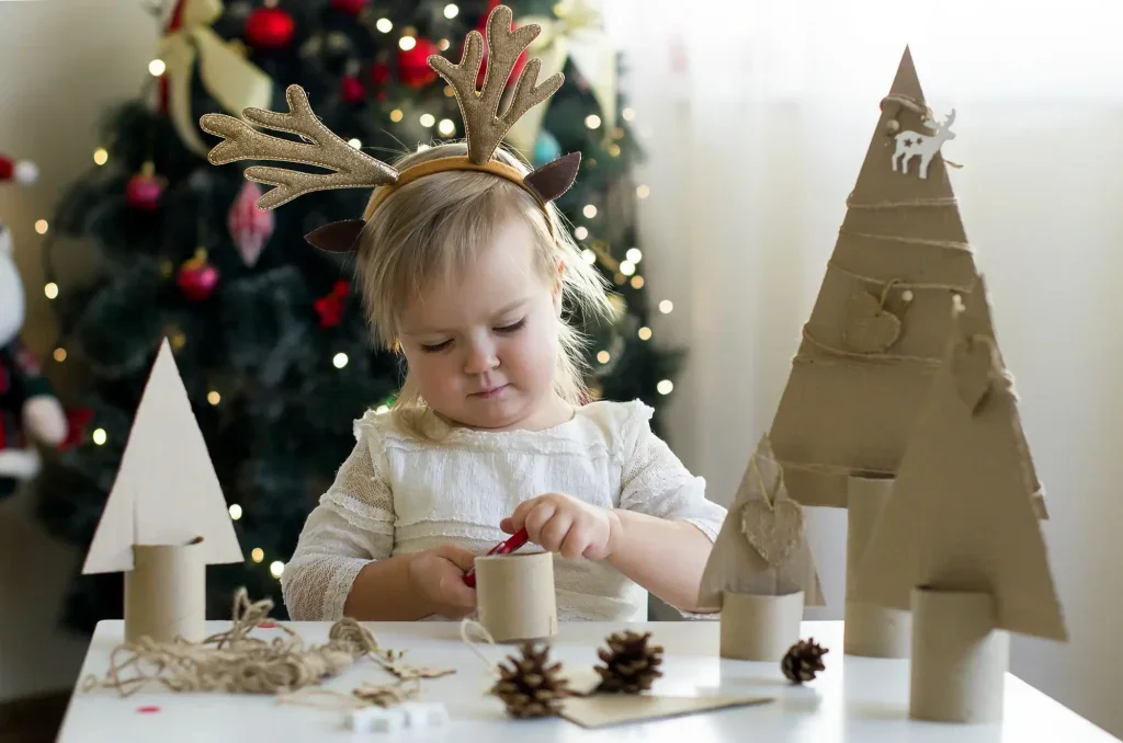 dítě vyrábí vánoční dekorace