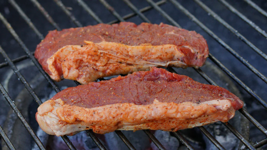 grilled meat on charcoal grill